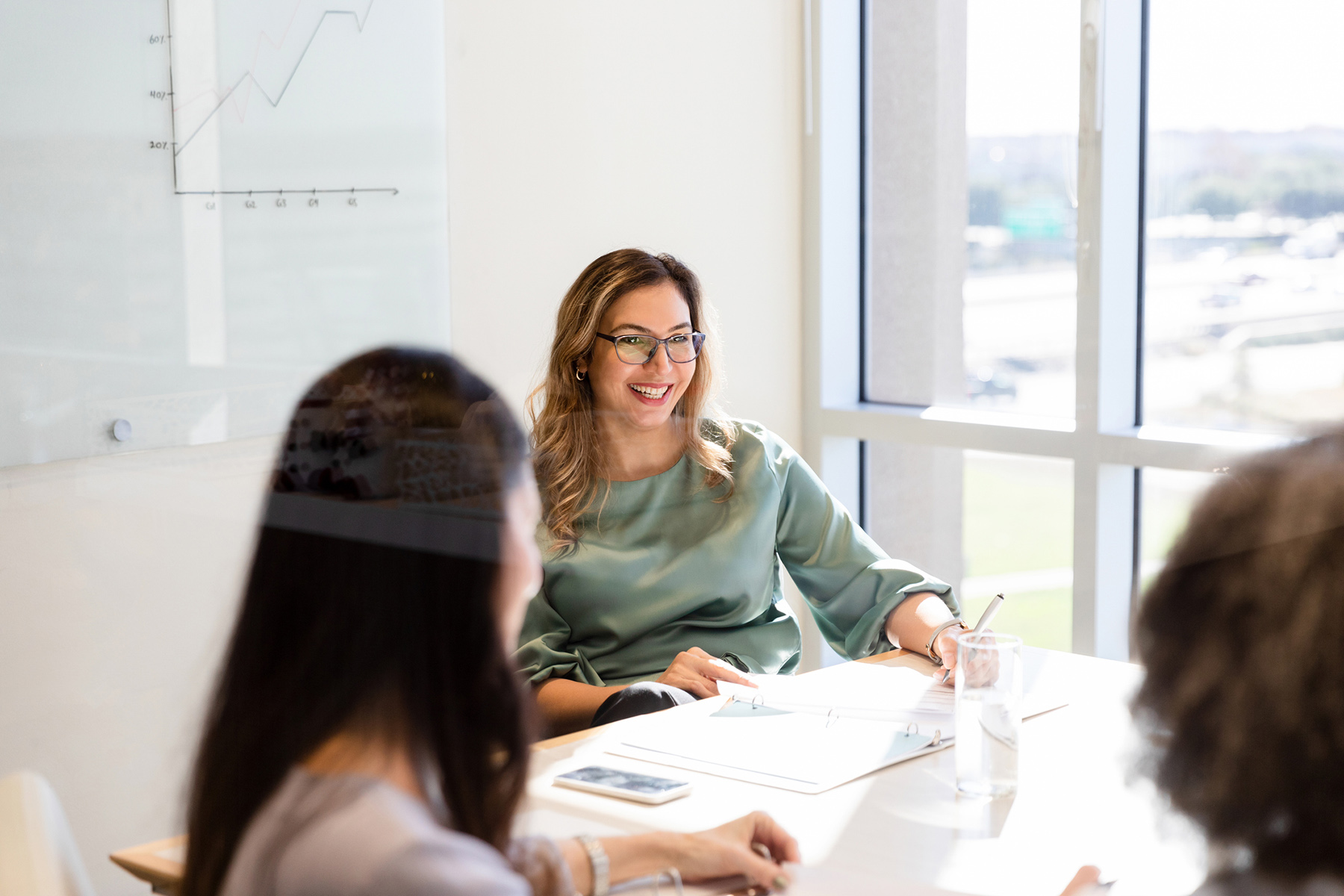 Female marketing agent smiling and talking in the meeting ATI Resource